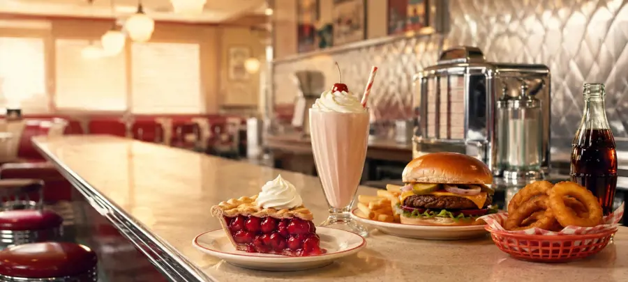 Classic snacks, candies, diner food, and nostalgic treats arranged on a tabletop for food trivia